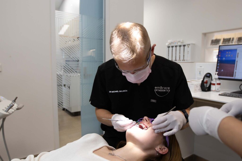 Orthodontist providing adult braces treatment at Embrace Orthodontics